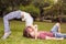 Young unusual kissing couple outdoors at park, in extreme position