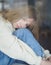 Young upset girl sitting on a windowsill on quarantine