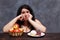 Young upset overweight woman bored of diets choosing between hea