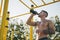 Young urban athlete drinking water at a calisthenics gym outdoor