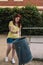 young urban girl with red hair, picking up rubbish from the ground to put it in a bin. young environmentalist in the