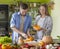 Young vegan couple cooking healthy food in the kitchen