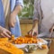 Young vegan couple cooking vegetarian soup in the kitchen