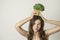 Young vegan woman with a green broccoli crown