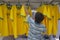 Young Vendor Arranging Brazil Shirts at Market