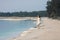 Young very beautiful girl with long hair in a white dress by the lake.