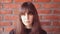 Young very upset brunette woman with bangs wearing a black t-shirt ashamed on brick wall background