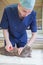 young veterinarian combs a street gray kitten at a volunteer aid animal station, provides him with first aid