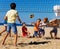 Young volleyball players in action on sand court