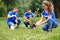 Young volunteers planting trees in park. Charity work