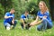 Young volunteers planting trees in park. Charity work