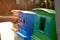 Young volunteers throw waste into the bucket, cleaning area in park, People and ecology.