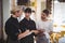 Young wait staff discussing over tablet computer at coffee shop