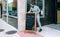 Young waiter placing a blackboard with the daily menu outdoors