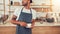 Young waiter standing at the cafe counter