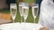 Young waitress carrying a tray with six glasses of champagne.