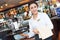 Young waitress at service in restaurant