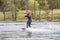 Young wakeboarder rides a wakeboard on the lake. Wakeboarding is cool, extreme sport