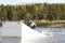 Young wakeboarder rides a wakeboard on the lake. Wakeboarding is cool, extreme sport