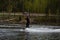 Young wakeboarder rides a wakeboard on the lake. Wakeboarding is cool, extreme sport