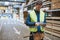 Young warehouse worker consulting a tablet