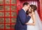 Young wedding couple posing in red english call