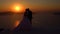 Young wedding couple on the rooftops of Santorini, Greece sunset