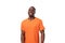 young well-groomed slender African guy dressed in an orange t-shirt with a mockup on a white background with copy space