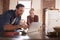 Young white couple using laptop in kitchen, close up