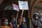 Young white girls with medical masks holding a banner during anti-racism demonstration