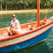 Young white tourist girl in the Asian boat. Nature.