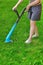 Young White Woman Holding A Corded Grass Trimmer