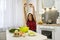 Young wife preparing salad with vegetables add salt and pepper for better taste