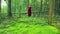 A young witch in the forest performs a ritual with a staff.