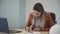 Young woman accountant working with financial document sitting at table in office room.