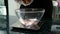 Young woman is adding chocolate biscuits into bowl on scales in kitchen.