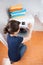 Young woman adjusting dial on washing machine