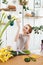 Young woman admire the beautiful flowers in workshop