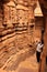 Young woman admiring interior of Jain temple, Jaisalmer, Rajasthan, India