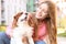 Young woman with adorable Cavalier King Charles Spaniel dog