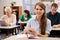 Young woman at adult education class looking to camera