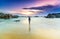 Young woman alone standing alone on the beach