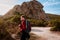 Young woman alone walking in the corsican countryside looking at the view, concept of adventure holidays traveling alone