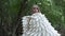 Young woman angel costume with white wing closeup looking at camera