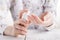 Young woman applies cream on her hands. On a white background