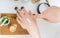 Young woman is applying homemade cosmetics on her skin