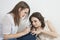 Young woman applying nail paint to friend\'s fingernails