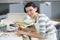 Young woman apprentice painter sitting at working table