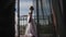 A young woman approaches the window, opens to a balcony, enjoying. morning bride waiting for wedding