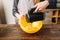 Young woman in apron whip dough in bowl with mixer